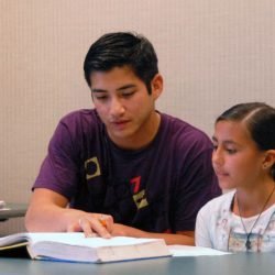 Second Lt. Patrick Leary, 412th Test Support Squadron acquisition manager, helps Vanessa Olmos, a local student, with her mathematics homework. About 20 Edwards company grade officers volunteer their time and effort at the Wanda Kirk Rosamond Library to help children prepare for math tests, homework and make-up work. (Photo by Airman Mike Young)